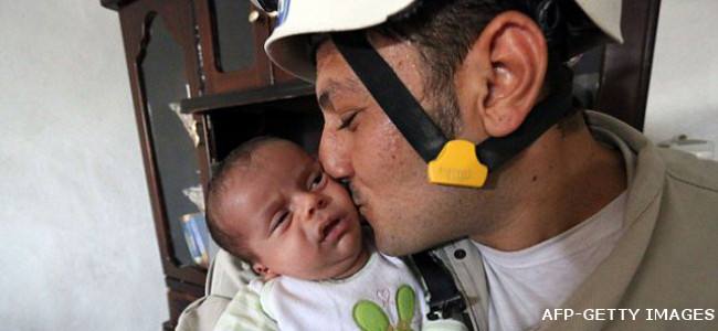 Civil Defense rescuer save from rubber a newborn after a bomb attack in Aleppo