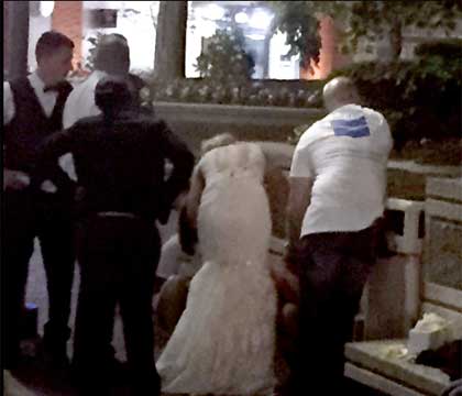 New bride in wedding dress gives CPR to woman on street
