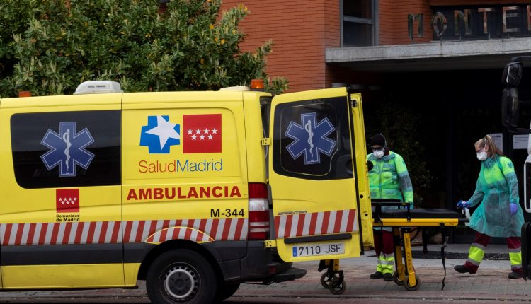 Spain’s King Felipe decorates a rescue driver for work as a volunteer ambulance driver during the pandemic
